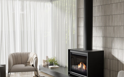 Modern living room with a black Escea freestanding gas fireplace.